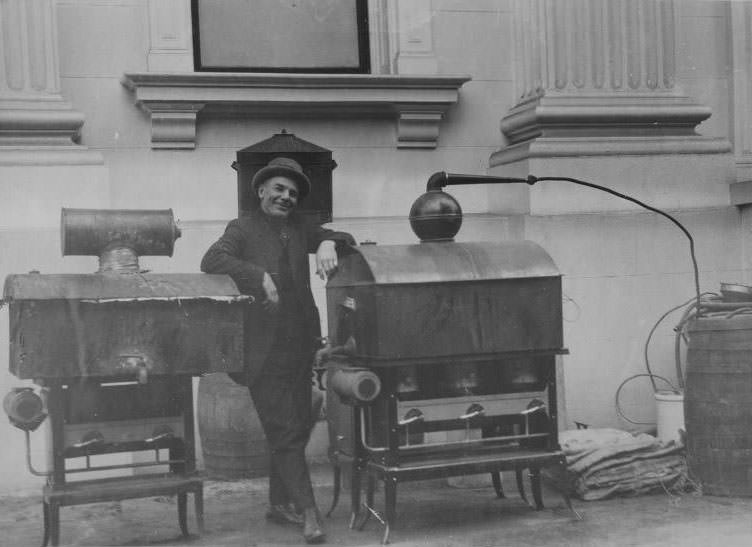 #38 Man posing with two confiscated stills, 1925