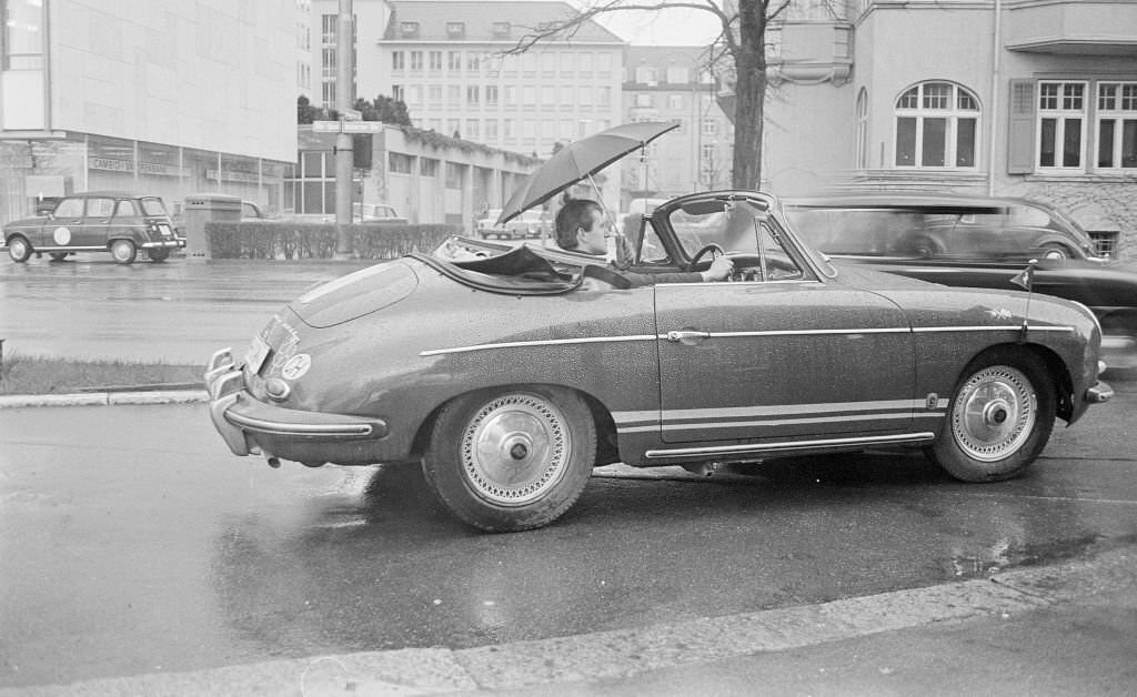 #188 Man with umbrella in a convertible, Zürich, 1970