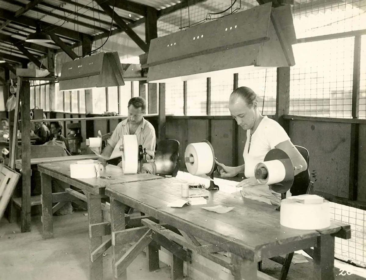 #20 Paper inspection. At these tables, each roll of finished work is inspected letter by letter and all badly reproduced letters are marked out.