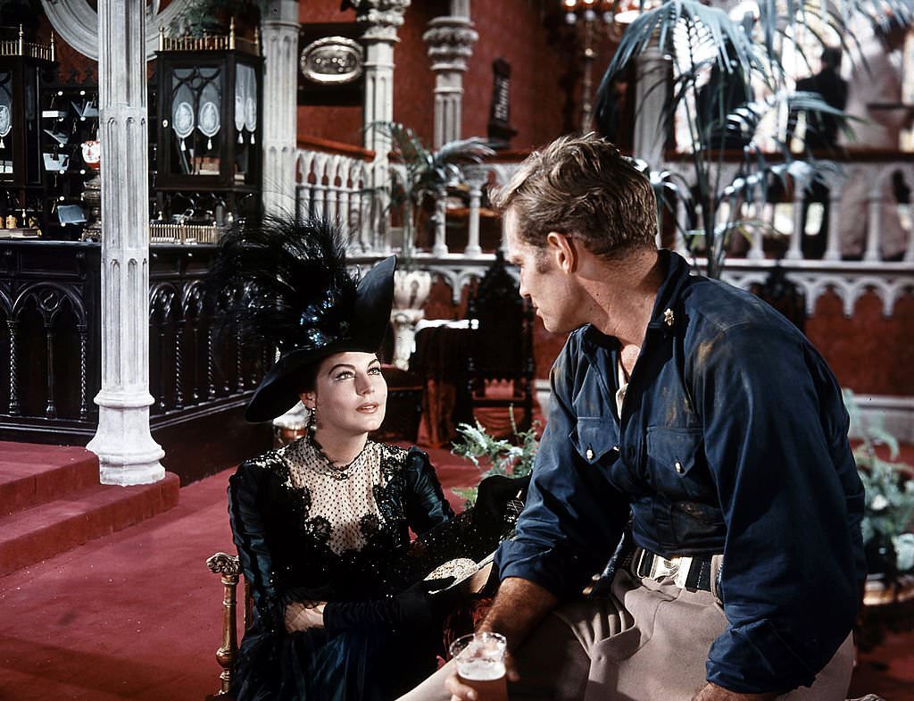 Ava Gardner catches the attention of Charlton Heston in a scene from the film ’55 Days At Peking’, 1963.