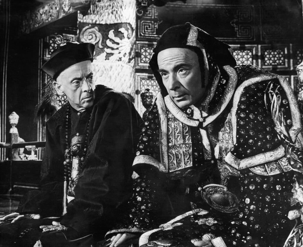 Robert Helpmann looking over at Leo Genn in a scene from the film ’55 Days At Peking’, 1963.