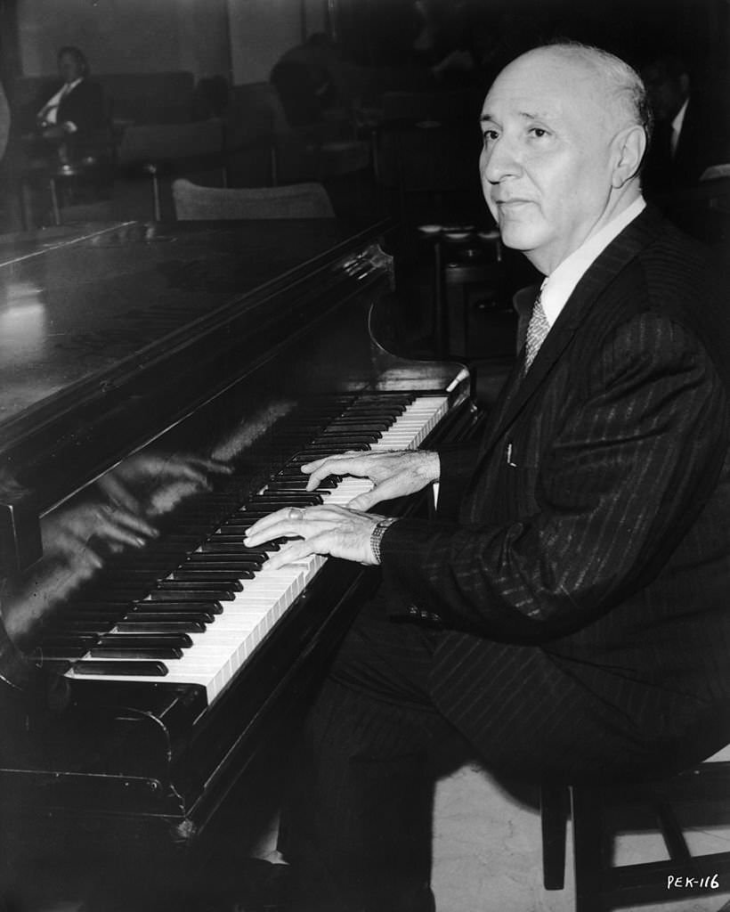Ukrainian film score composer Dimitri Tiomkin working on the music for ’55 Days at Peking’, 1963.