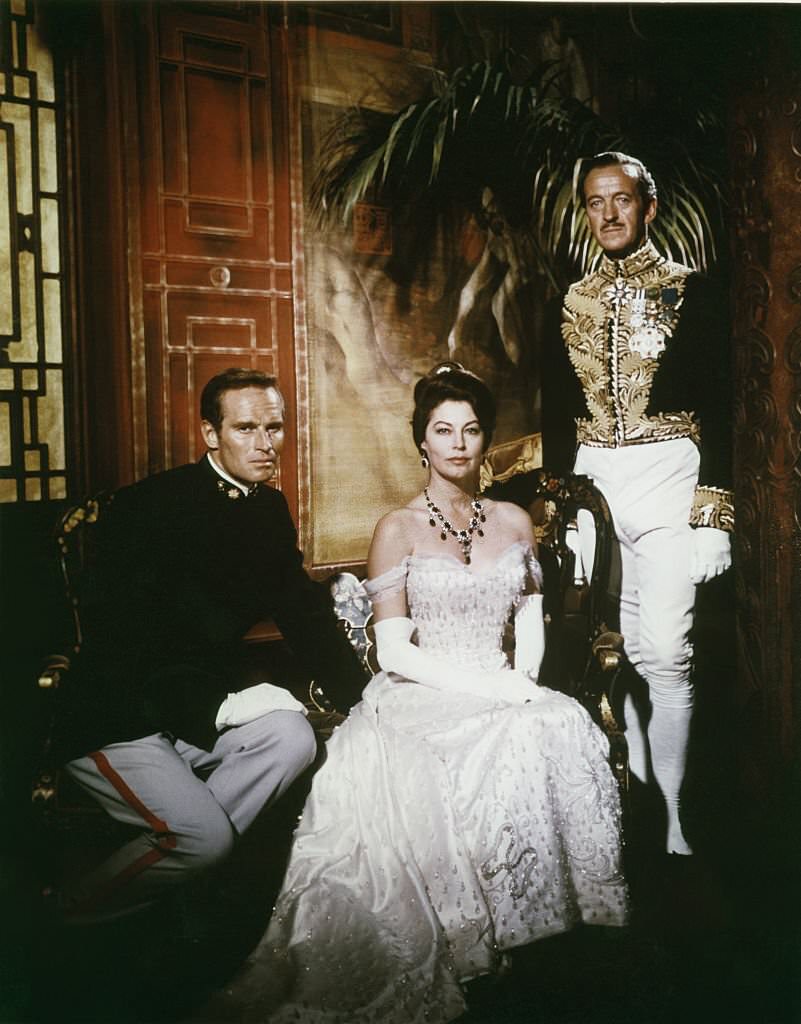 American actors Charlton Heston, David Niven and actress Ava Gardner on the set of ’55 Days At Peking’, 1963.