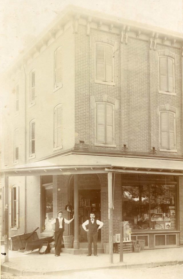 #14 Two men outside corner general store, 1880s