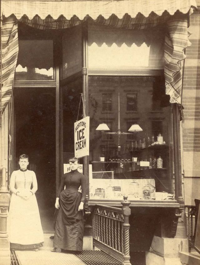 #18 Two women outside store selling Horton’s ice cream, 352 Pleasant St., New York, 1880s