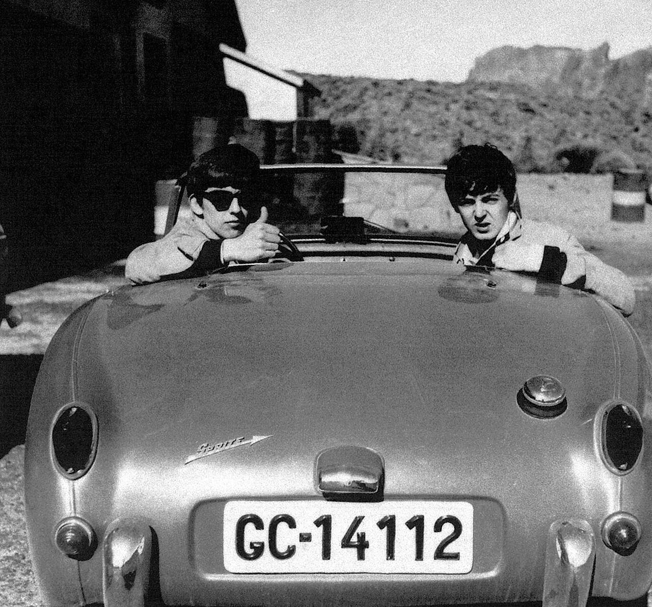 #11 George Harrison and Paul McCartney in pal’s Austin Healey Sprite