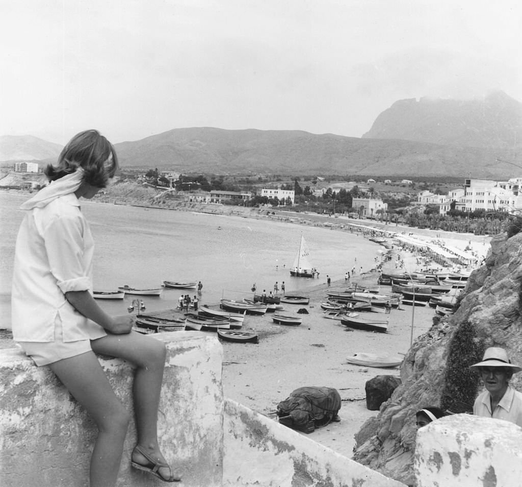 #10 A tourist admiring the view over the beach at Benidorm, July, 1963