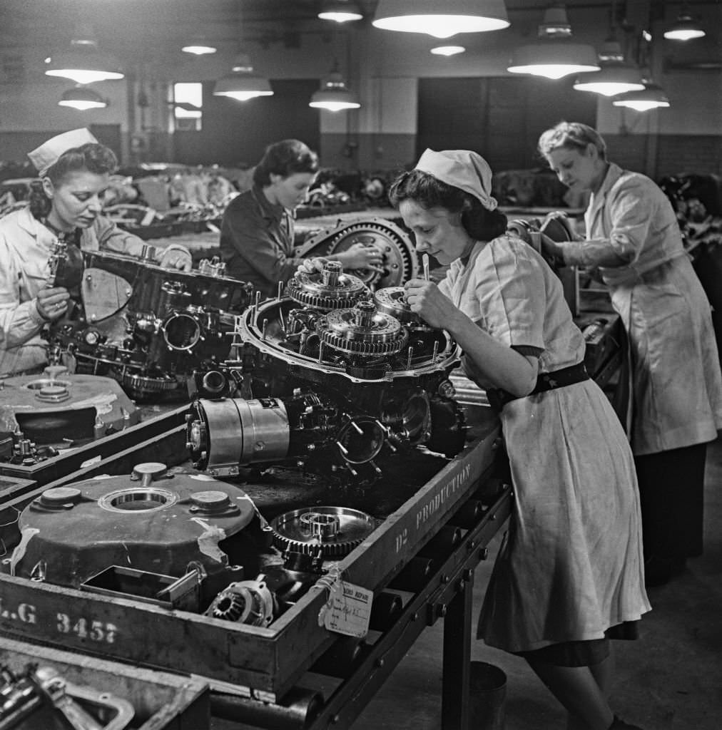 #107 Female factory workers assemble parts, possibly the reduction gear, for Rolls-Royce Merlin V-12 piston aero engines at the Hillington Rolls-Royce aero engine factory in Glasgow, Scotland on 30th November 1942.