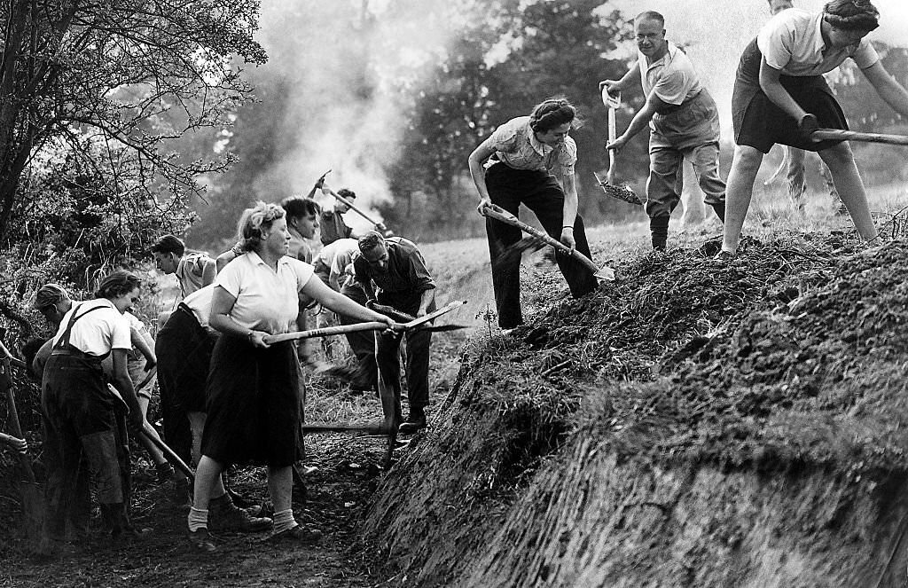 #114 A “Ditching” party of Women of the Volunteer Land Corps at work digging a deep drainage ditch in the fields at Cheshunt