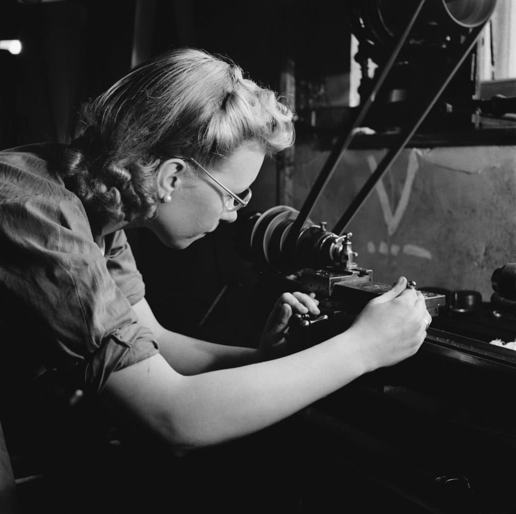 #146 A young woman training for war work in the machine shop of the Ministry of Labour training centre at Chelsea Polytechnic, later the Chelsea College of Arts in London, July 1941.