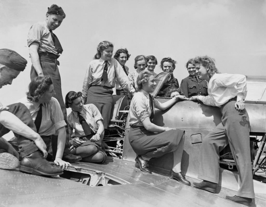 #151 Jacqueline Cochran far right, American pilot Jacqueline Cochran talks to members of the Women’s Auxiliary Air Force at work on a Hawker Hurricane MkIIb fighter aircraft of 242.