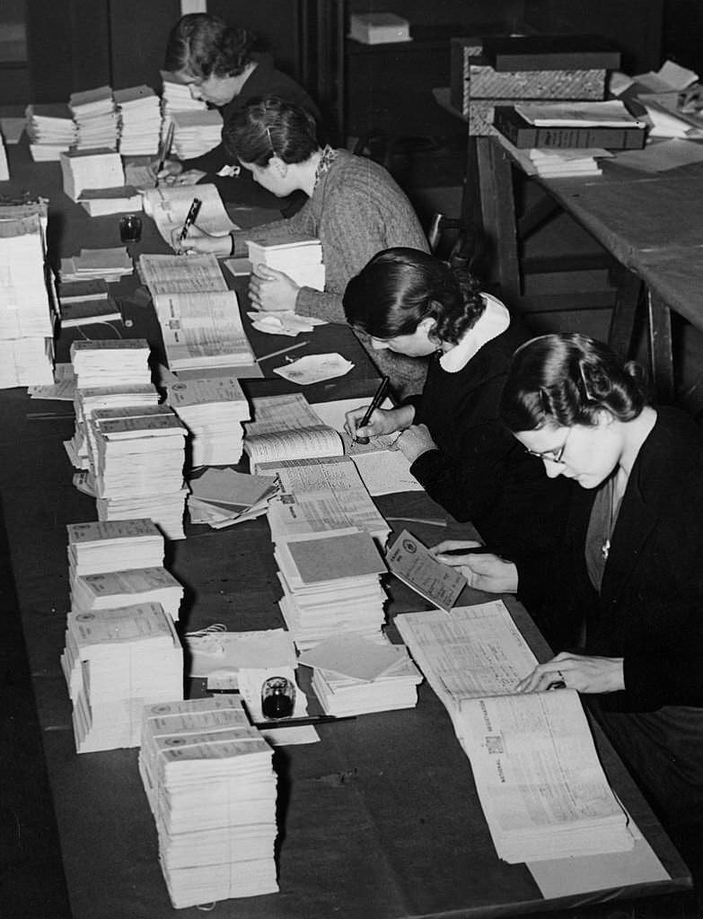 #16 Women at the Food Executive Office in London prepare ration books from the National Registration returns.