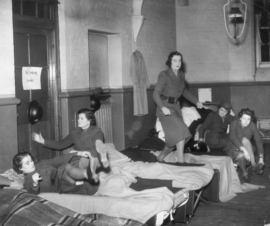 #17 Members of the Mechanised Transport Corps in their dormitory where they sleep with their clothes when on duty, 1940