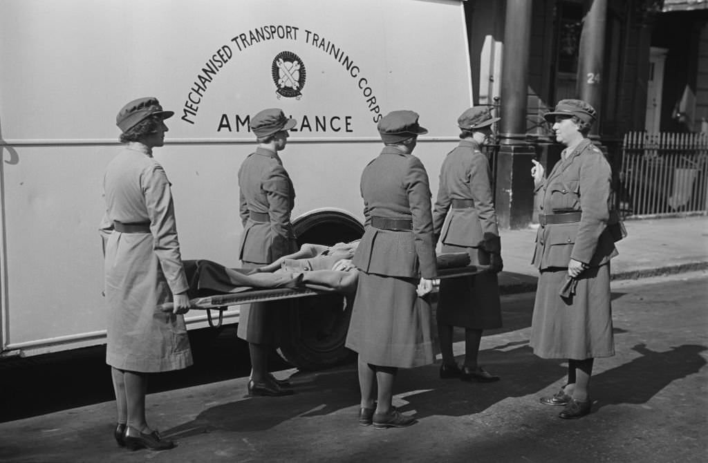#20 Commandant of the Women’s Mechanised Transport Training Corps (MTTC), Mrs G M Cook gives instructions to four female MTTC stretcher bearers beside an ambulance in London on 28th September 1939.