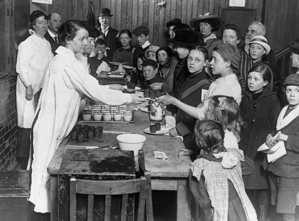 #39 Women serving children meals in communal kitchens.