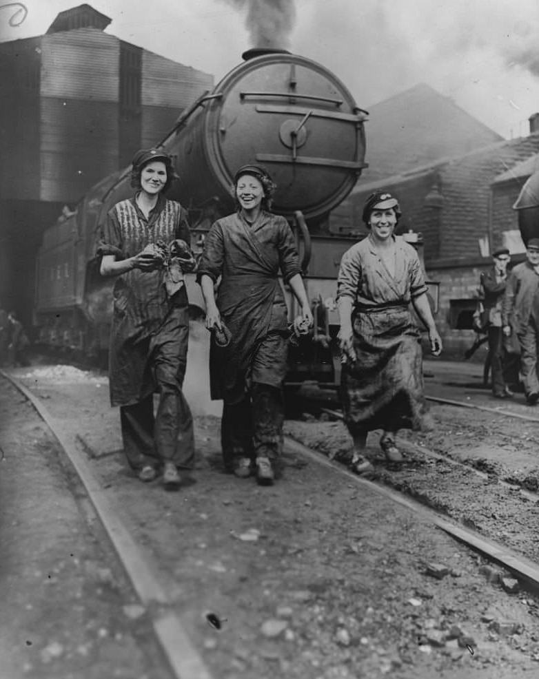 #44 Three cleaners, nicknamed the Three Musketeers, who are employed to clean and maintain locomotives at the London and North Eastern Railway yard, Northern England, June 1941.