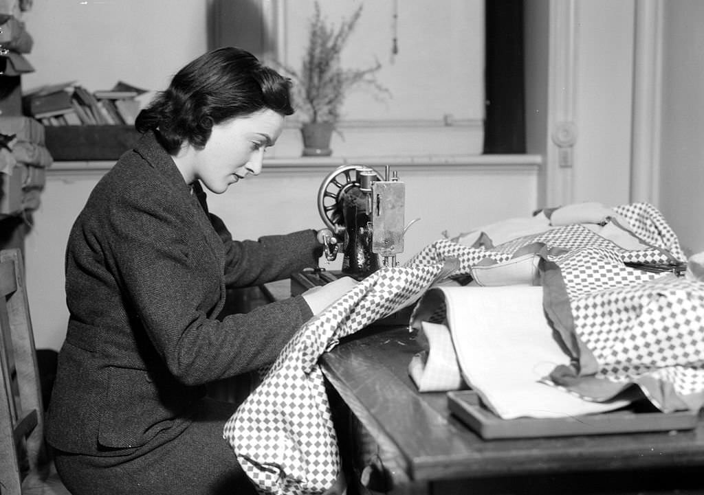 #6 Lady Reading using a sewing machine at the Women’s Voluntary Services headquarters during world War II.