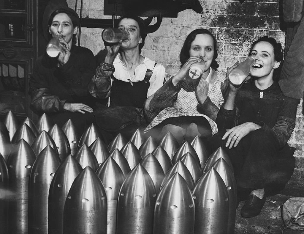 #63 Women workers in a munitions factory drinking milk during their break, 1941.