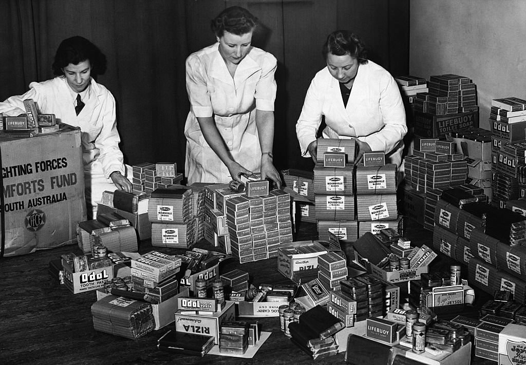 #71 Women prepare care packages of chocolate, tobacco, cigarette papers, toothpaste, razor blades, and soaps for British troops, all gifts from the South Australian Fighting Forces Comfort Fund.