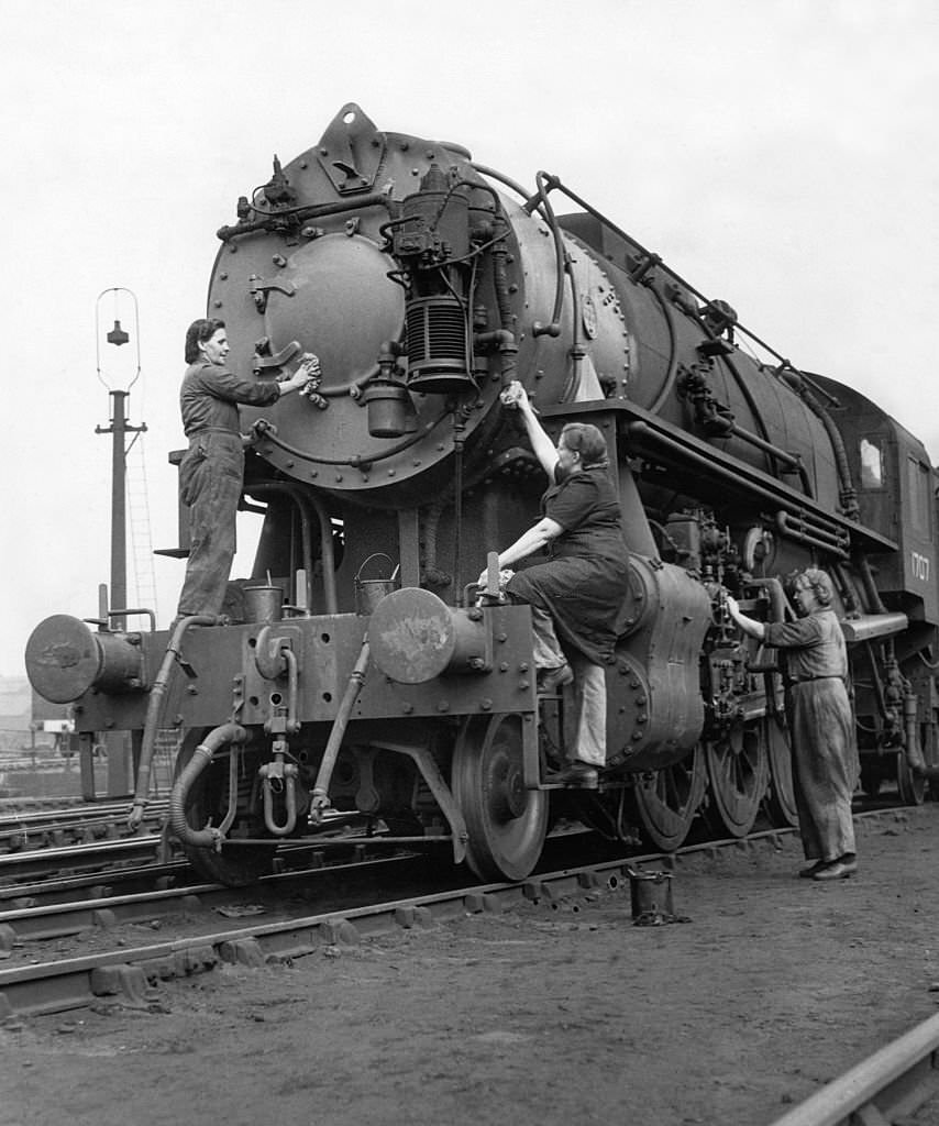 #95 An American locomotive, one of the first batch to arrive in the United Kingdom for many years, being cleaned by women.