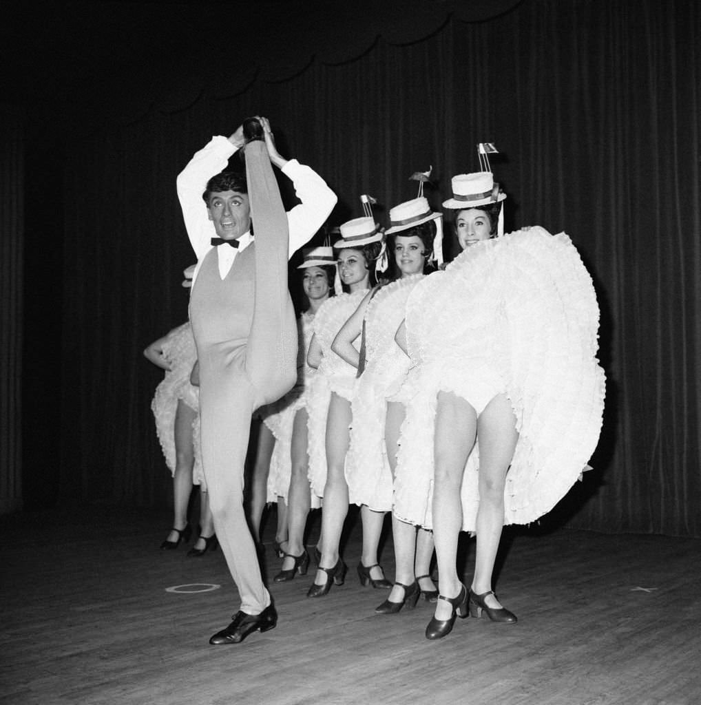 #36 Star dancer Jean-Pierre Charnas during his number with the cancan dancers in the new revue ‘Frou-frou’ at the Moulin Rouge, in Paris, 1964