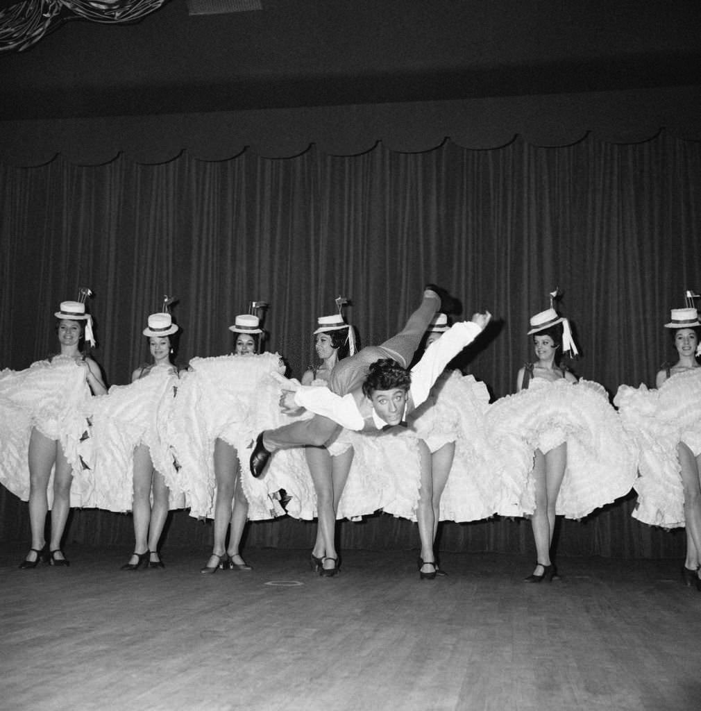 #38 Star dancer Jean-Pierre Charnas during his number with the cancan dancers in the new revue ‘Frou-frou’ at the Moulin Rouge, in Paris, 1964