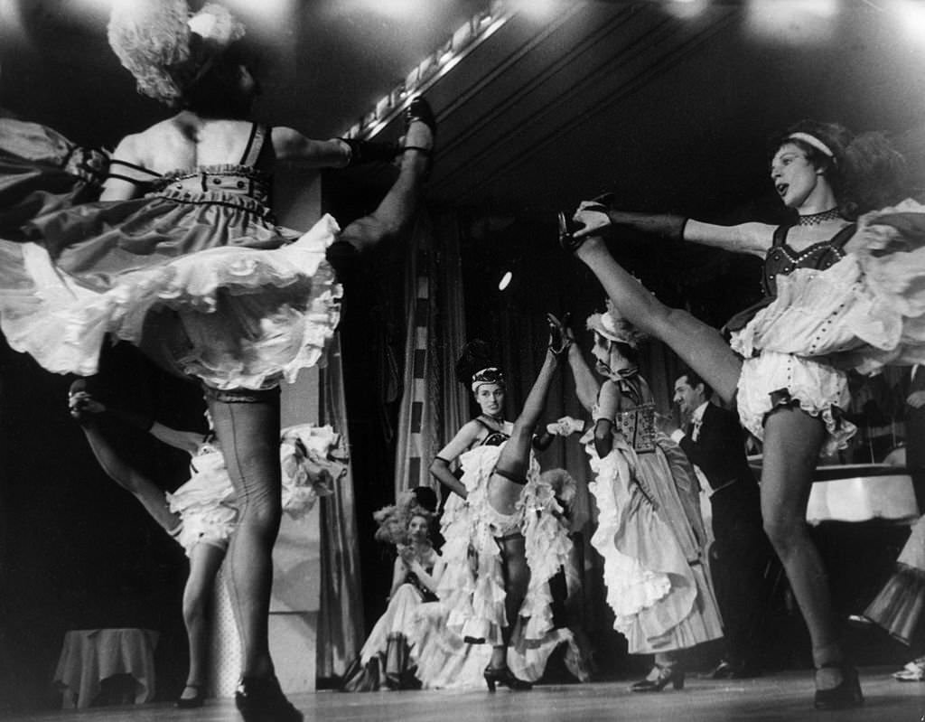 #54 Can-Can dancer Regine performing on stage at the Moulin Rouge theatre in Paris, 1955.