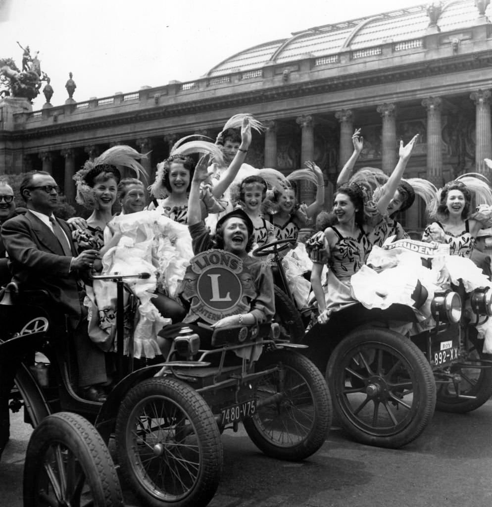#59 The French cancan dancers of the Moulin Rouge give the start of the ‘crusade of prudence 54’ in front of the Grand Palais in Paris, 1954