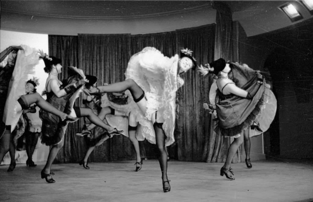 #1 A troupe of can-can dancers leave little to the imagination during a performance of ‘The Blue Bird’, a cabaret show at London’s Pigalle restaurant celebrating the coronation year of Queen Elizabeth II, 1953.