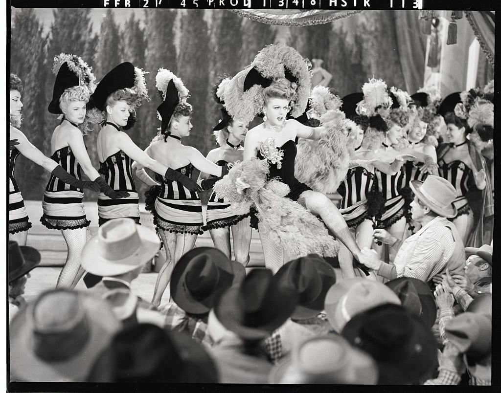 #78 Ladies of the Chorus: Angela Lansbury, who portrays em, a dance hall queen, in MGM’S musical “The Harvey Girls,” puts her all into her work as she leads the chorus in an old-fashioned “can-can.”