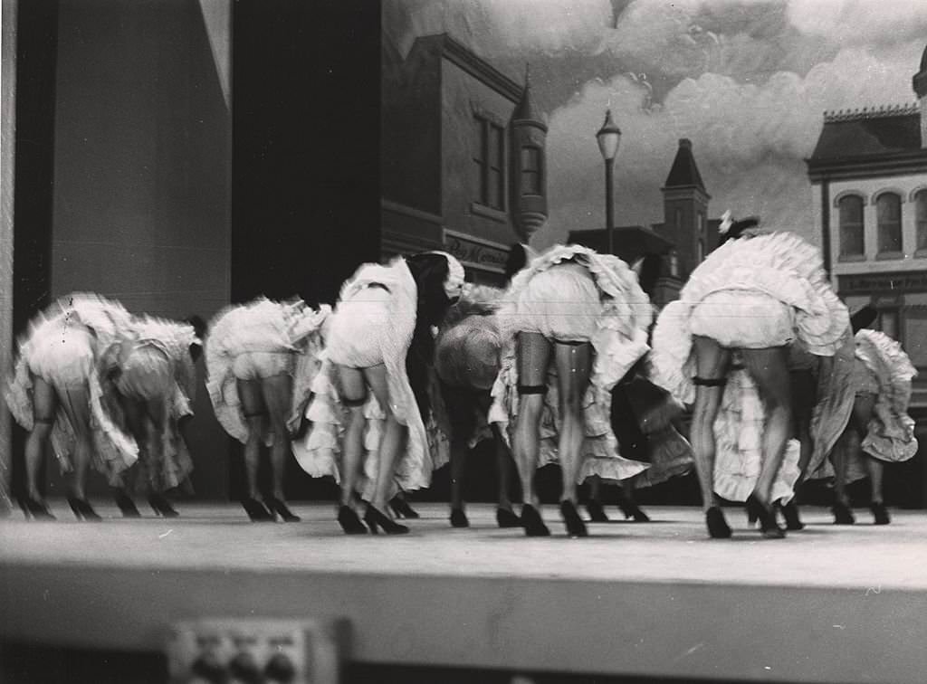#81 Men dressed as women dancing on stage, with their backs to the audience, New York, 1940s.