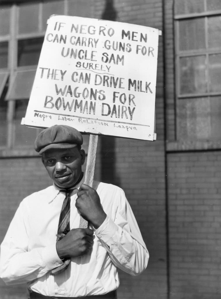 #6 A man holds a sign which reads: ‘If Negro men can carry guns for Uncle Sam, surely they can drive milk wagons for Bowman Dairy,’, Chicago, Illinois.