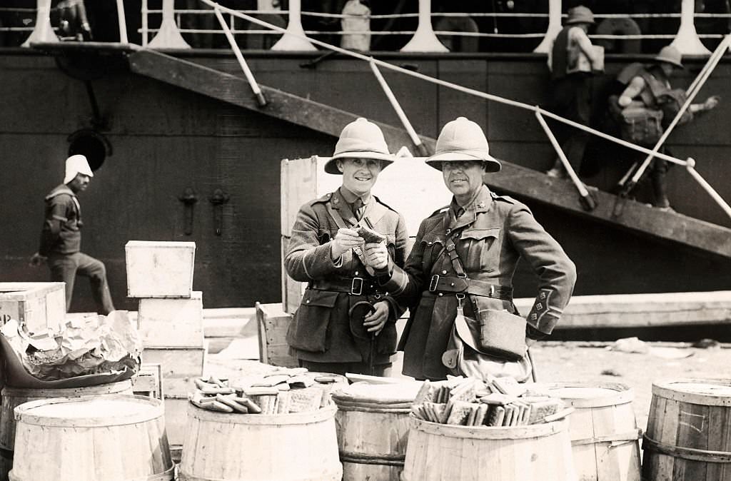 #47 Wedgwood Benn MP (left) tasting the biscuits that were supplied to the troops for that day’s rations on landing at Alexandria during World War One, 1915.