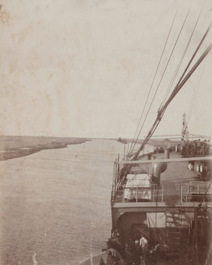 #63 A view of the Suez canal with ship’s deck in foreground, 1910s