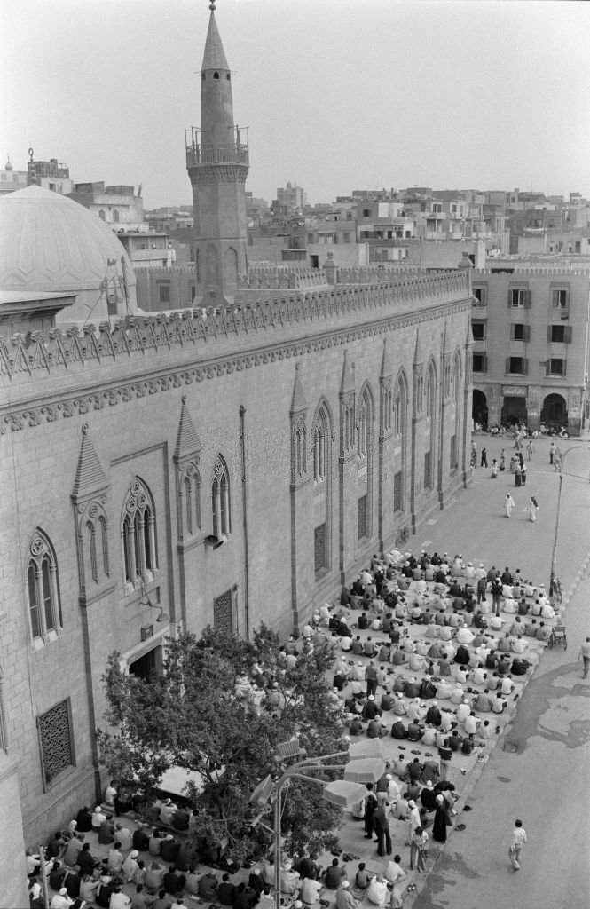 #146 People praying in front of a mosque on a street in Cairo in October 1978