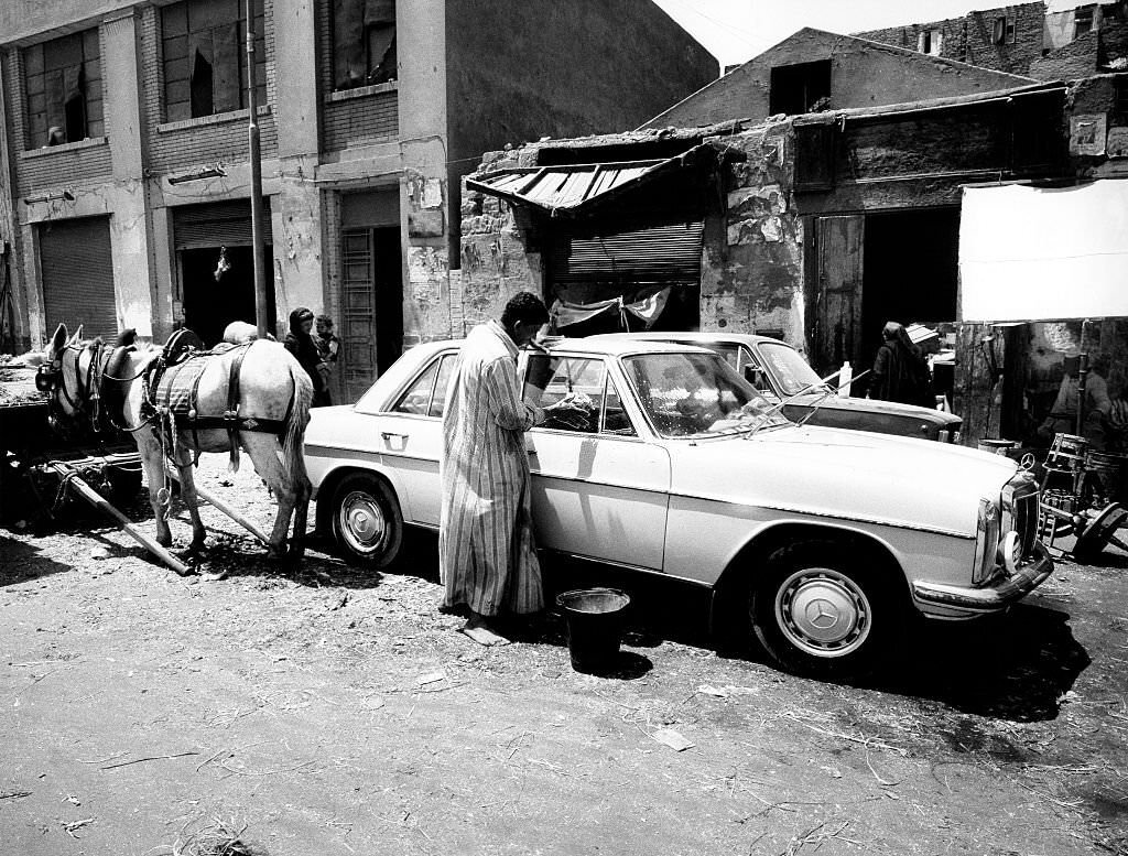 #181 Man cleaning his car in Cairo, 1976