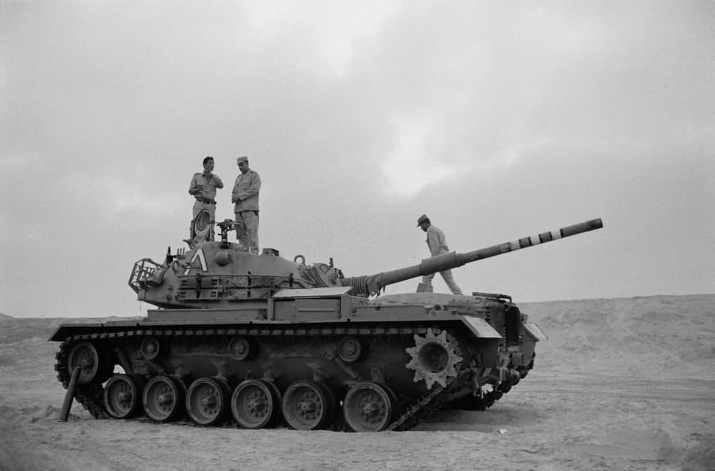 #34 Egyptian soldiers on a tank captured from the Israeli army near the front at the Suez Canal during the Yom Kippur War in October 1973
