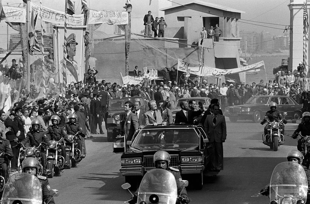 #96 Jimmy Carter and Anwar el-Sadat wave to the crowd during the US President’s visit to Cairo, 1979