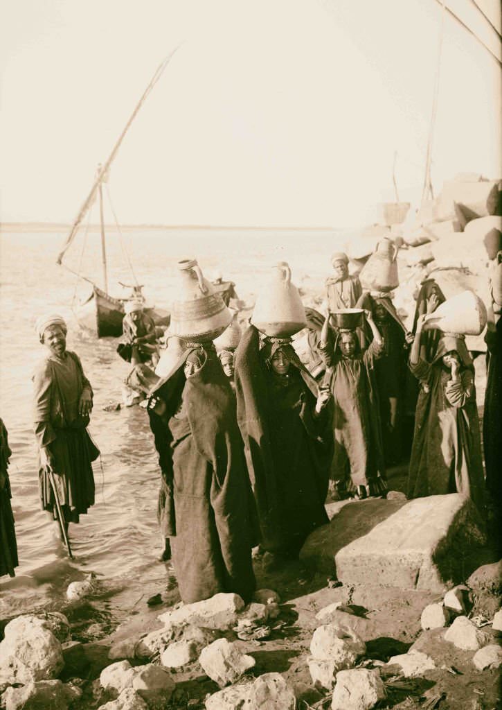 #114 Native women with jars carrying water from the Nile, Egypt, 1900.