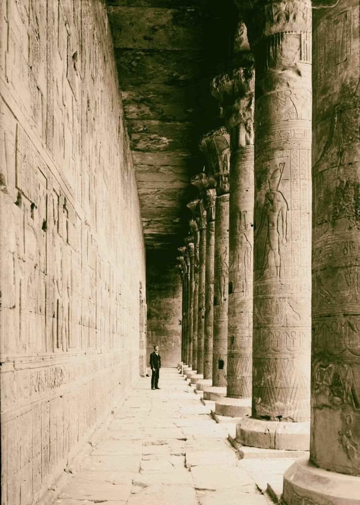 #142 Temple of Horus, Edfu. Colonnade in court showing carving on pillars, 1900.