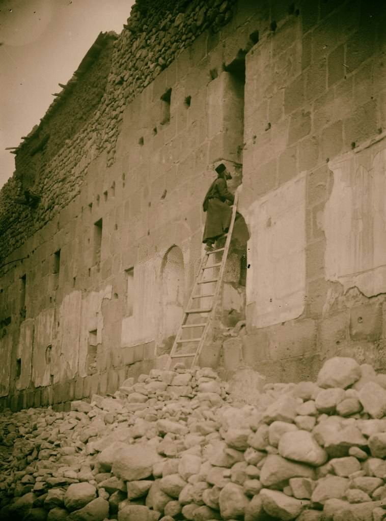 #164 Sinai via the Red Sea, Tor, and Wady Hebran. Monk climbing up to his cell-chapel [Monastery of St. Catherine] in Sinai, Egypt, 1900