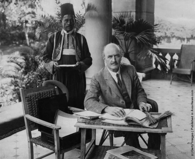 #245 English soldier Edmund Henry Hynman Allenby, 1st Viscount Allenby, at work on the verandah of the Residency at Cairo with his Egyptian servant.