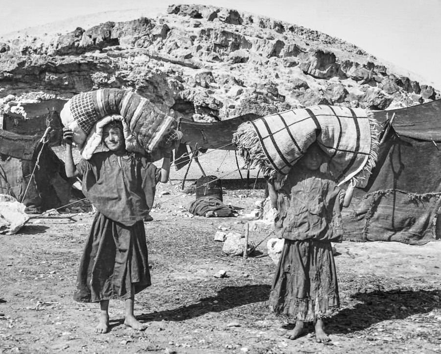 #88 Victorian/Edwardian.Social History. An expidition in Cairo boys carrying their beds from base camp, 1900s