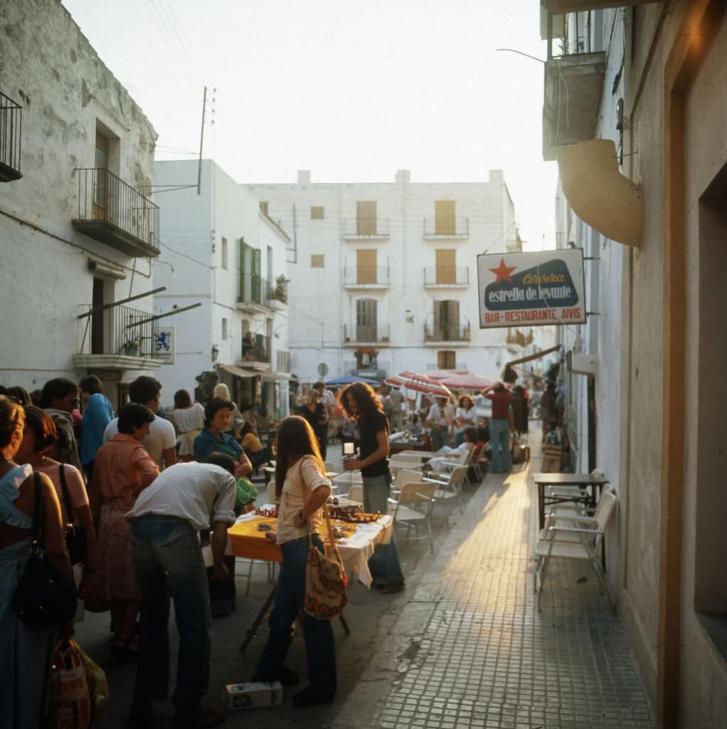 #26 Shopping at a hippie market in the city of Ibiza, 1976