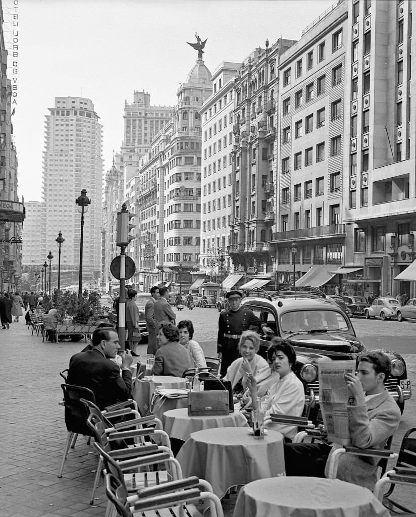#88 Several people on a terrace on the Gran Via during the 1960s in Madrid, Spain.