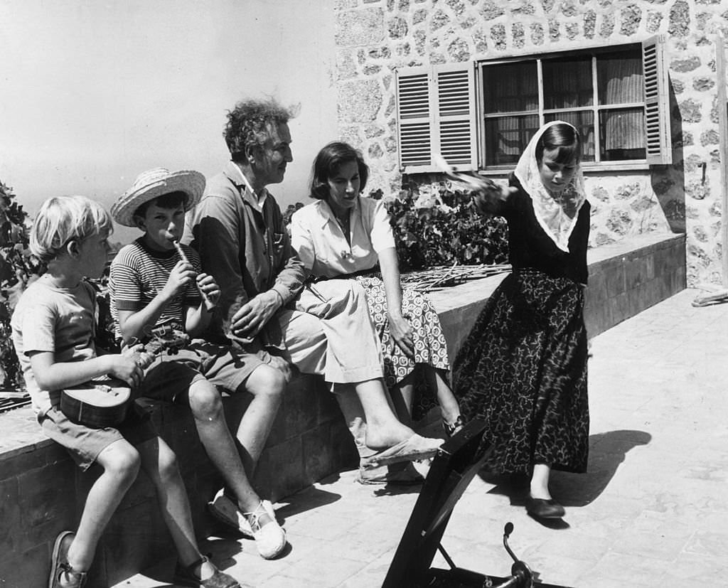 #101 English poet, writer and classical scholar Robert Ranke Graves with his second wife Beryl and his children outside their holiday home in Deya, on the island of Majorca, 1954