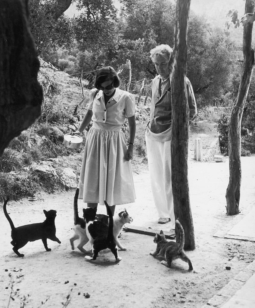 #121 Robert Graves watches his wife Beryl feeding cats in Deya, Majorca, January 1954.