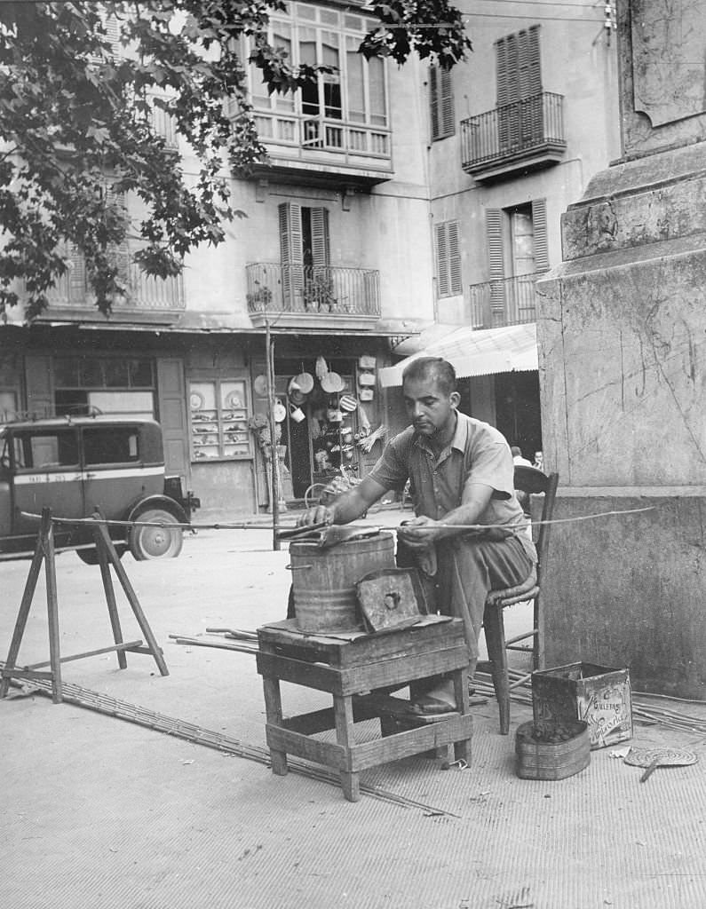 #128 Palma de Mallorca, a craftsman works on the street, Mallorca, 1950