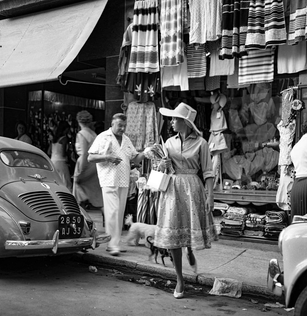 #77 Actress and singer Abbe Lane walks through the streets of Mallorca, 1959