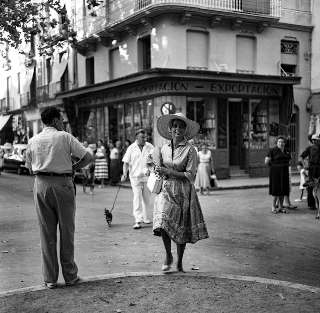 #78 Actress and singer Abbe Lane walks through the streets of Mallorca accompanied by her husband Xavier Cugat and their dog.